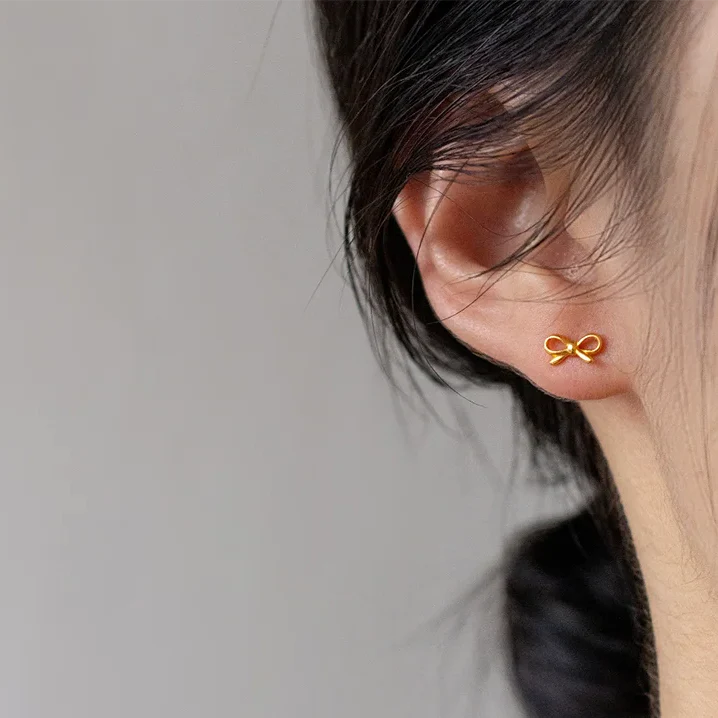Minimalistische Ohrringe mit goldener Fliege