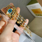 Hängende Ohrringe mit blauem Auge und Strass