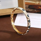 Armband mit Blumen- und Blättermotiven aus weißem und dunkelgrünem Farbemaille