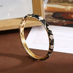 Armband mit Blumen- und Blättermotiven aus schwarzem Farbemaille