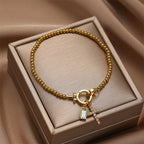 Armband mit Kreuz und Geburtsstein