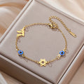 Armband mit Schutzsymbolen blaues Auge, Chai und dem <span data-glossary-id="davidstern">Davidstern</span> Gold