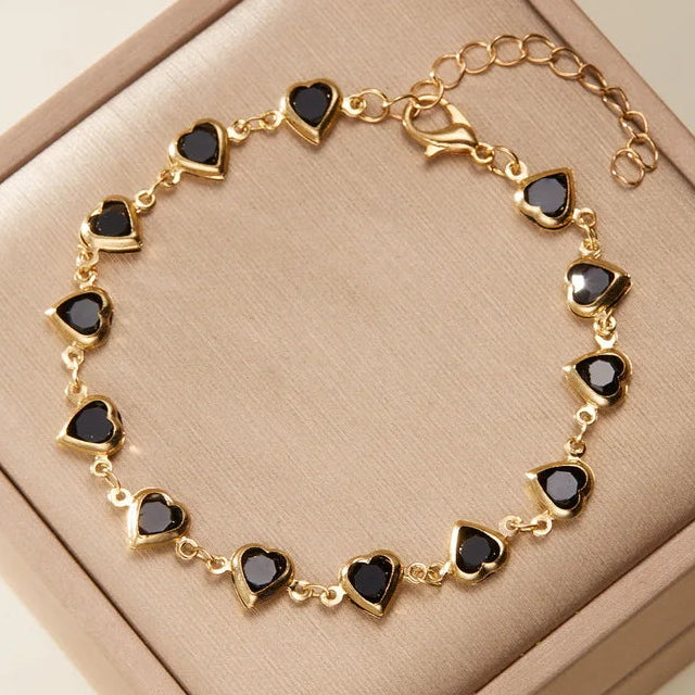 Armband mit emaillierten Herzen in Gold und Schwarz