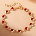 Armband mit emaillierten Herzen in Gold und Rot