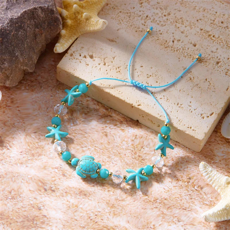 Kordelarmband mit Muschel und blauem Seestern-Schildkröte