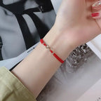 Bracciale con cordoncino intrecciato e simbolo infinito portafortuna rosso