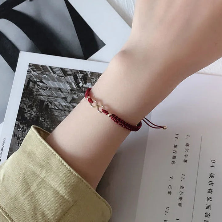 Bracciale con cordoncino intrecciato e simbolo infinito portafortuna bordeaux