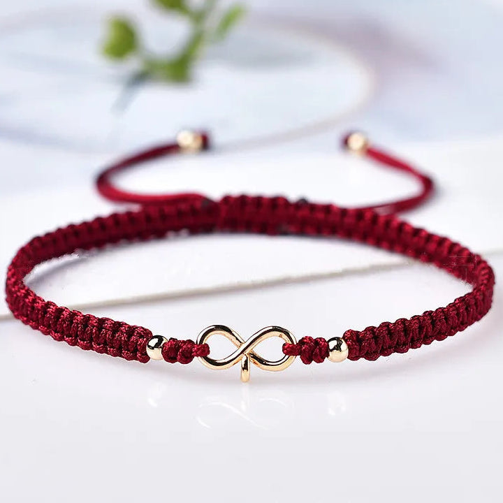 Bracciale con cordoncino intrecciato e simbolo infinito portafortuna bordeaux
