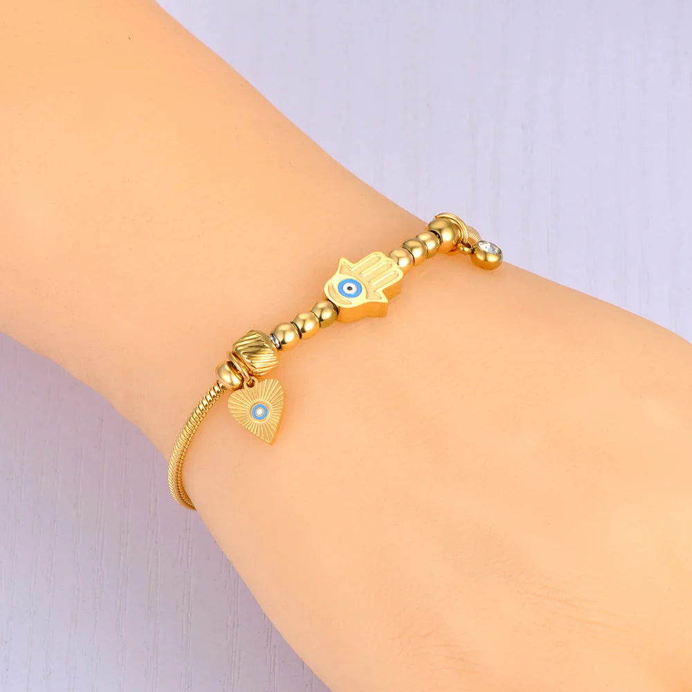 Schutzarmband mit Fatimas Hand und blauem Auge in Gold