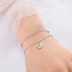 Vergoldetes Armband mit kleinem spiralförmigen silbernen Anhänger