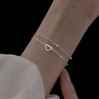 Armband mit doppeltem Herz und Perlen