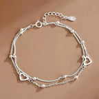 Armband mit doppeltem Herz und Perlen
