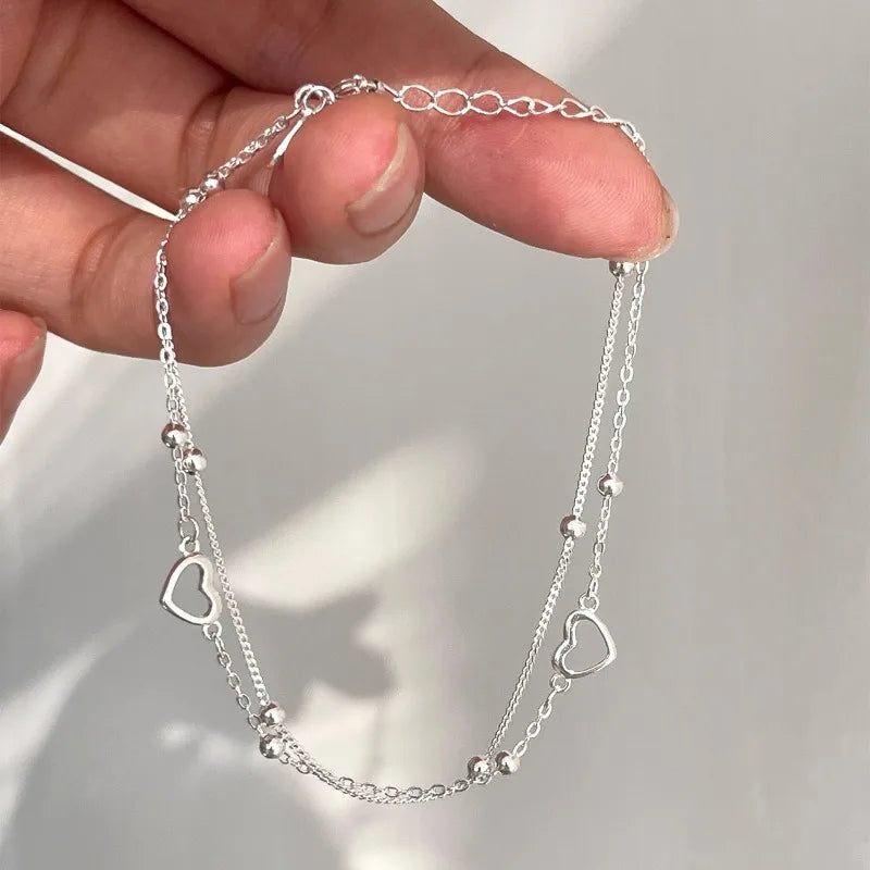 Armband mit doppeltem Herz und Perlen