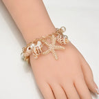 Elegantes Armband mit goldenen Muscheln