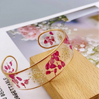 Armband Gourmette Blume aus transparentem rotem Harz a