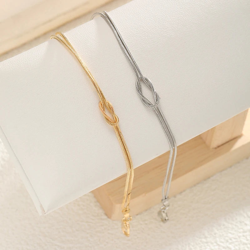Paararmband Verschlungene Knoten Gold und Silber (Set mit 2 Armbändern)