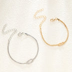Paararmband Verschlungene Knoten Gold und Silber (Set mit 2 Armbändern)