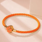 Geflochtenes Lederarmband mit vierblättrigem Kleeblatt orange