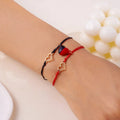Magnetische Partnerarmbänder mit Herz und EKG in Rot und Schwarz