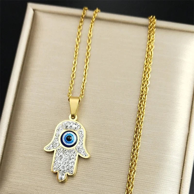 Lange Halskette mit Anhänger zum Schutz vor dem bösen <span data-glossary-id="œil">Auge</span> und arabischer Fatma-Hand in Gold