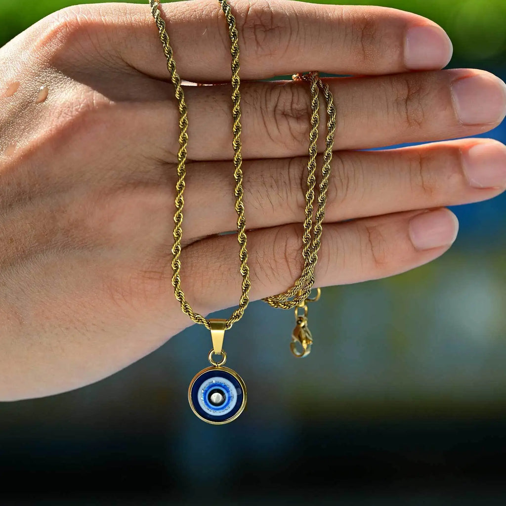 Collana ritorta con discreto pendente occhio blu oro