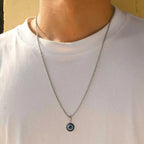 Collana ritorta con discreto pendente occhio blu argento