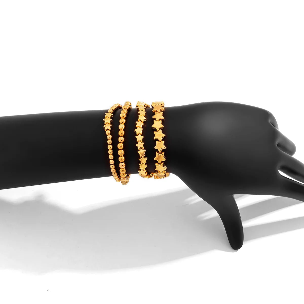 Set mit 4 goldenen Sternarmbändern
